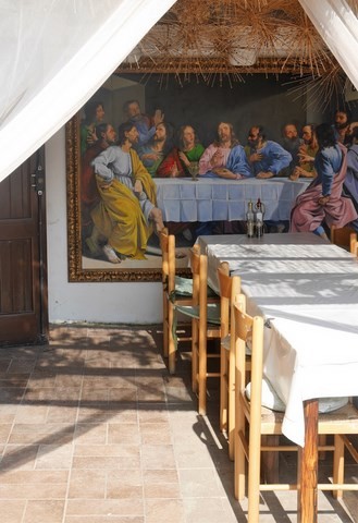 outdoor dining area with picture of the 'Last Supper' in the background