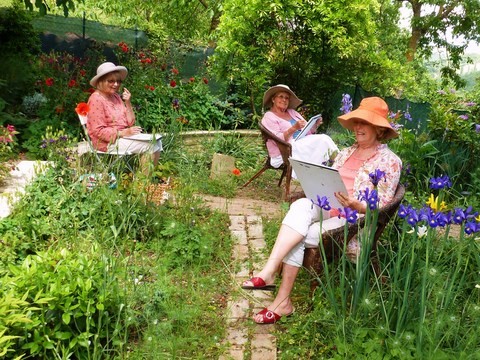 three ladies painting in the garden