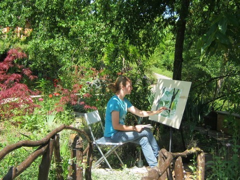 girl painting in the garden